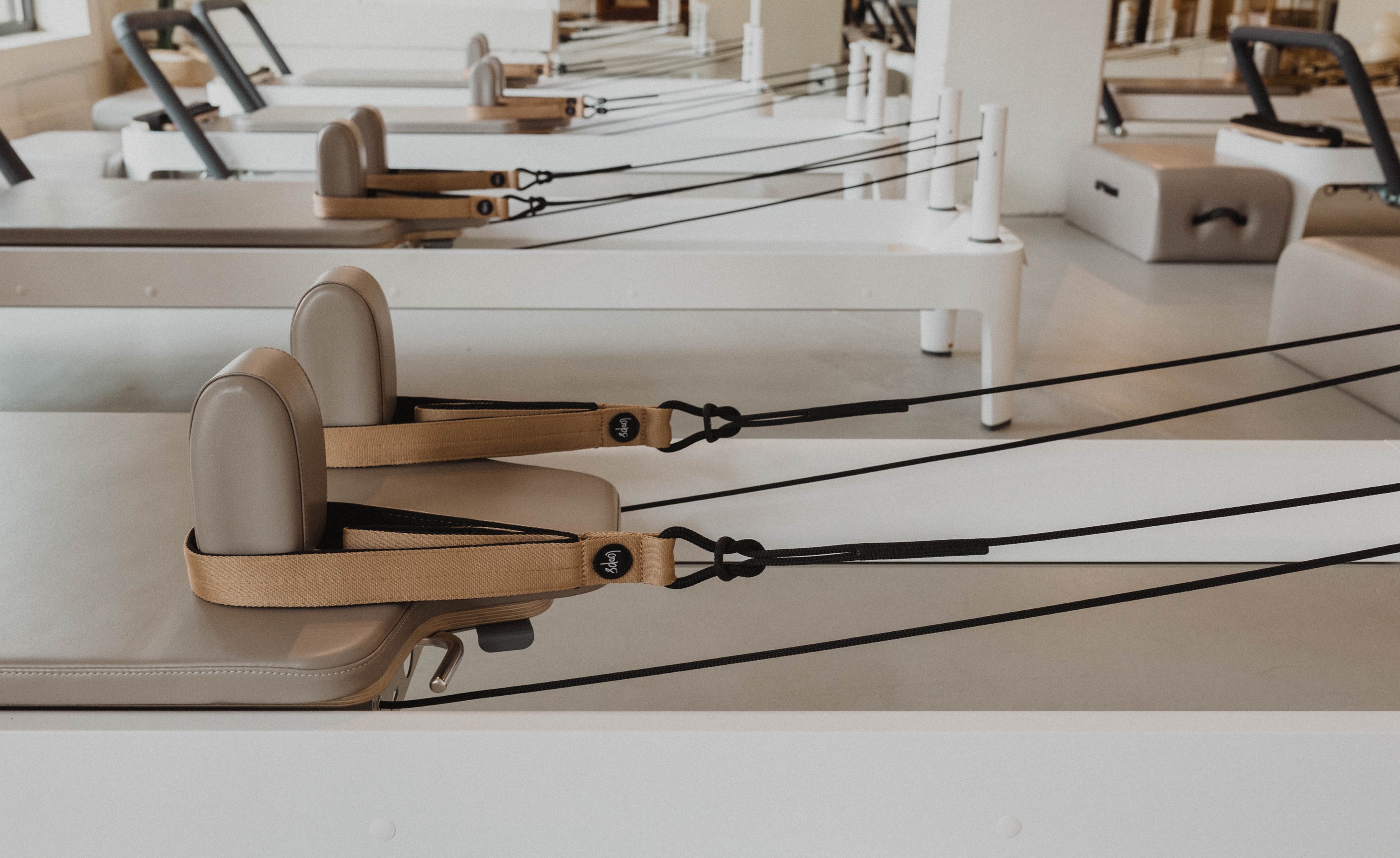 The Pilates Hub studio interior with reformer equipment in warm natural light